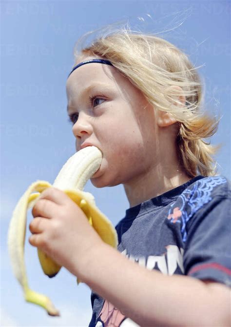 Boy Eating Banana Stock Photo