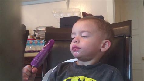 Sleepy kid struggles to finish his popsicle