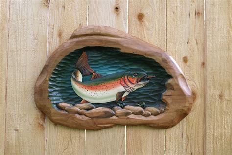 A Fish Carved Into The Side Of A Wooden Fence