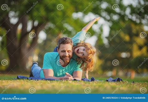 Happy Father And Son Enjoying Summer Time On Vacation In A Sunny Park Concept Of Healthy