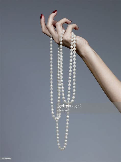 Hand Holding Pearl Necklace Photo Getty Images