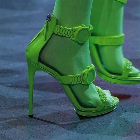 A Womans Green High Heeled Shoes On The Runway