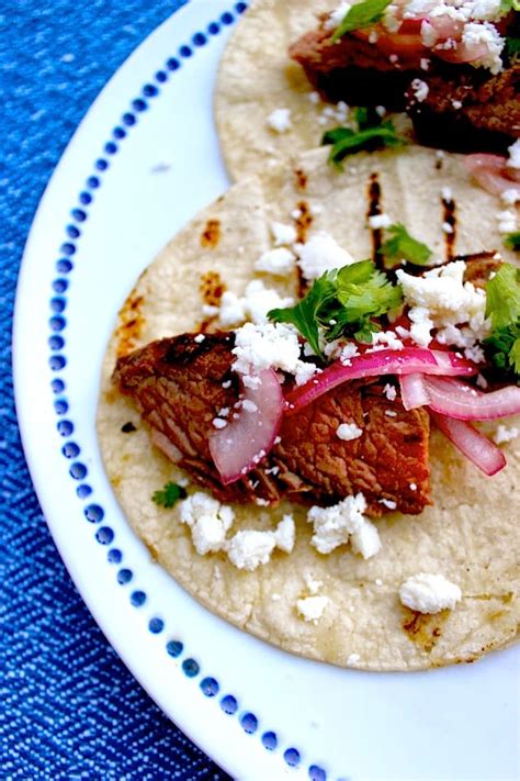 Queso (or chili con queso) has questionable origins, but for argument's sake, we'll just say texas has brought it to a level of fame usually reserved nonetheless, kudos to them. Grilled Steak Tacos with Pickled Red Onions and Queso Fresco