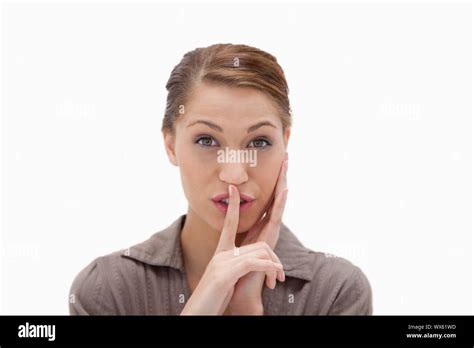 Woman Asking For Silence Against A White Background Stock Photo Alamy