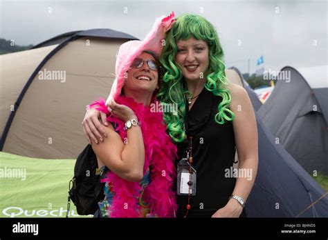 Two Girls With Vibrant Greenhair And Pink Boa In The Campsite At