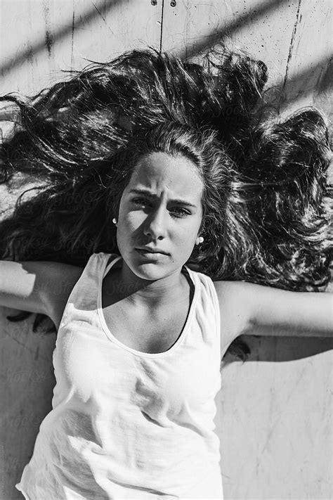Teenager With Long Hair Lying Down By Stocksy Contributor Victor