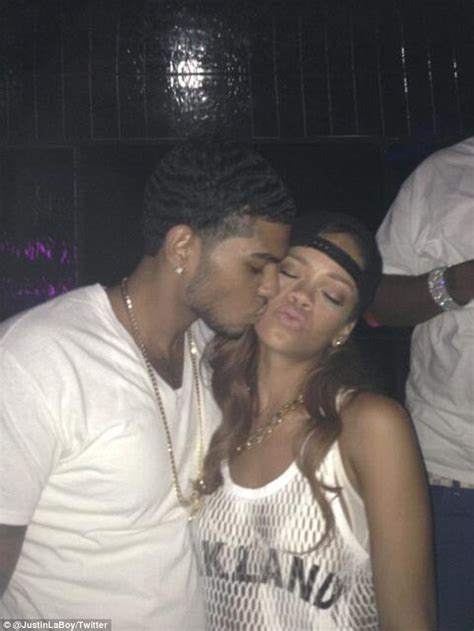 rihanna swaps kisses with a handsome fan as on off love chris brown unfollows her on twitter