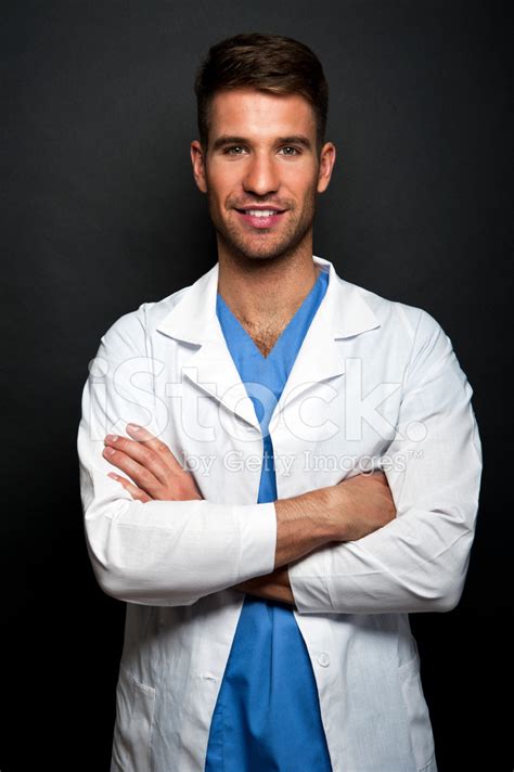 Portrait Of Confident Young Medical Doctor On Dark Background Stock