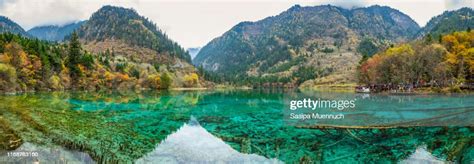 Panorama Of Crystal Clear Lake And Colorful Trees Reflection At