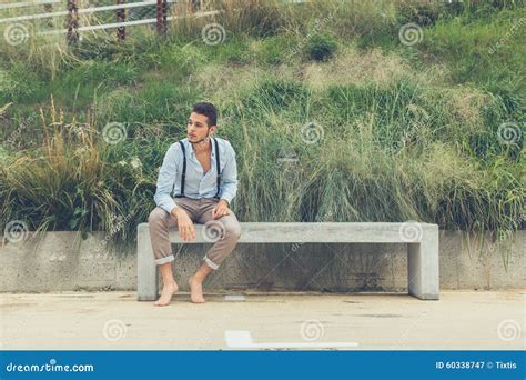 Young Handsome Man Sitting On A Concrete Bench Stock Image Image Of