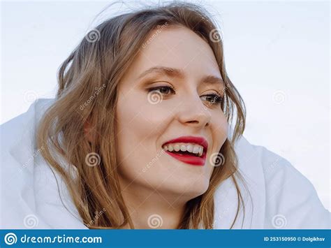 Portrait Of Happy Cheerful Young Woman With Red Hair Wrapped In A
