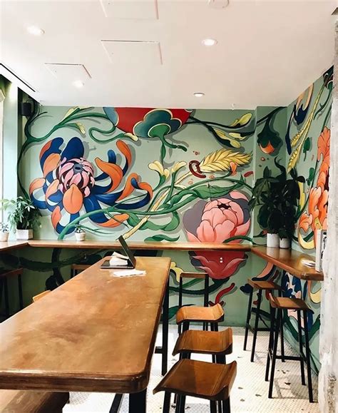 The Interior Of A Restaurant With Colorful Murals On The Wall And
