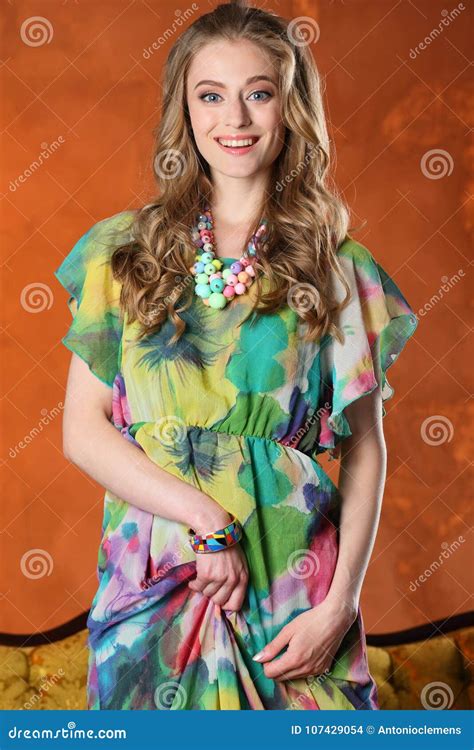 Pretty Slender Happy Blonde Girl Lifts Up Her Dress And Shows Her Long Legs Royalty Free Stock