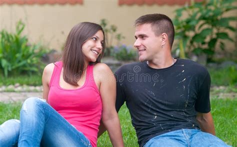 Beautiful Young Happy Couple Sitting In The Garden Stock Image Image