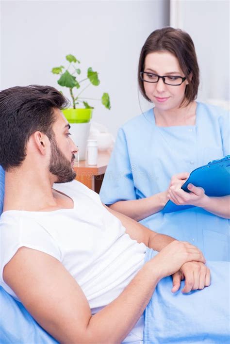 The Woman Doctor Examining Male Patient In Hospital Stock Photo Image