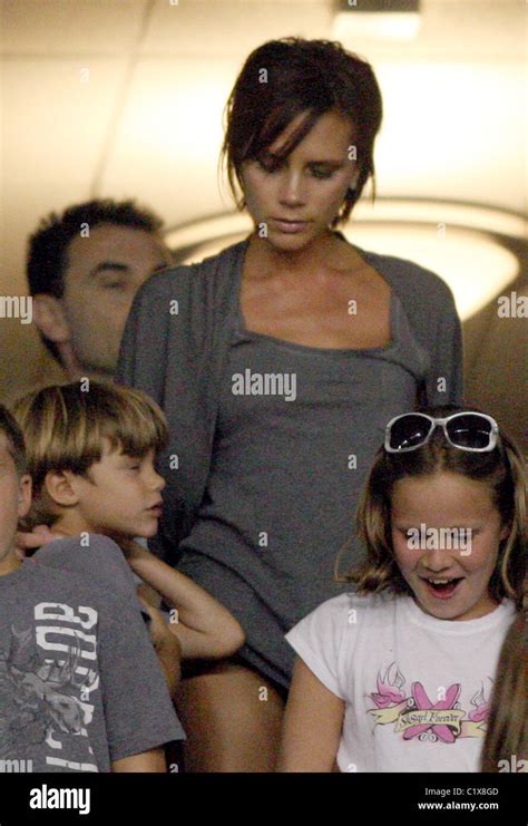 Victoria Beckham Flashes Her Leg As She Stands For The Usa National Anthem Prior To Her Husbands