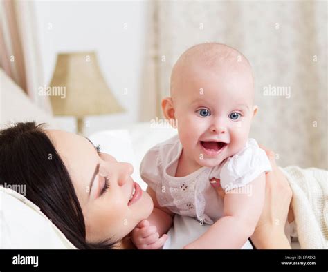 Happy Smiling Mother With Six Month Old Baby Girl Stock Photo Alamy