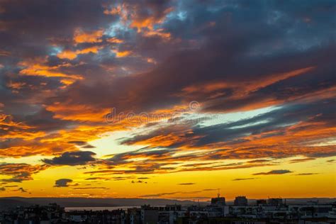 Sunset Fire In The Sky Over A Small City Dark Blue Clouds With Golen