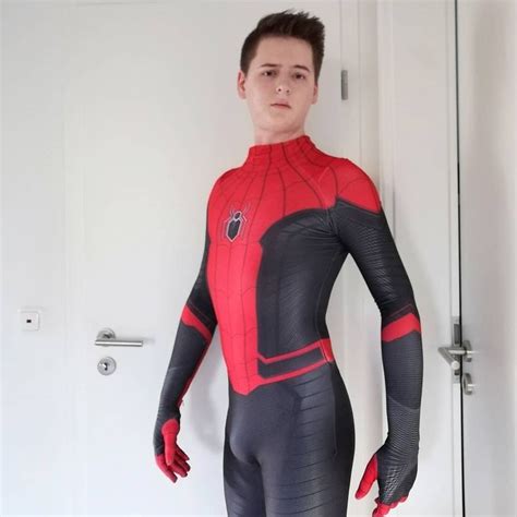 A Man In A Red And Black Spiderman Suit Standing Next To A White Door