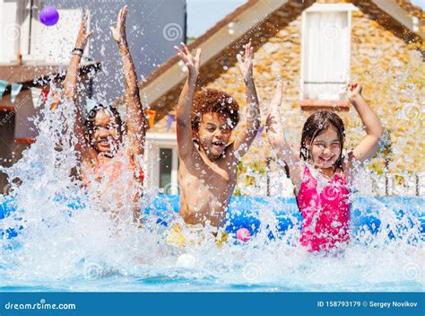 Portrait Of Three Kids Splash Water In Garden Pool Stock Image Image