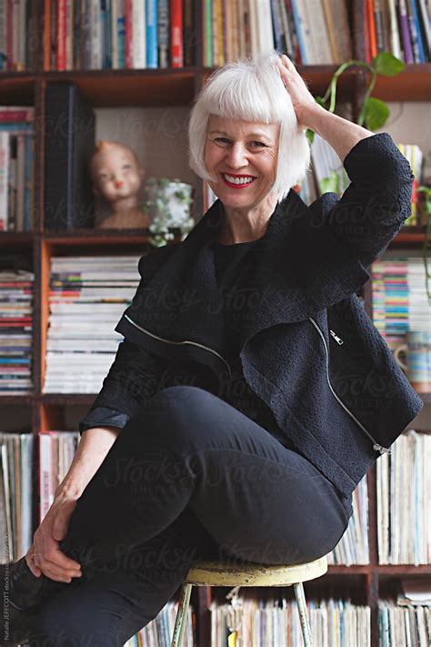 Stylish Older Woman Indoors In Front Of Books And Records By Stocksy