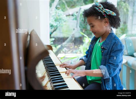 Adorable Girl Playing Piano At Home Stock Photo Alamy