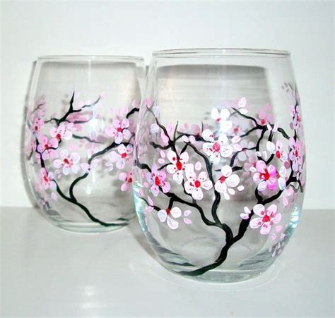 Two Wine Glasses With Pink Flowers Painted On Them