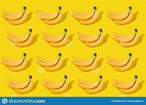 Bananas In Row Isolated On Yellow Background Stock Image Image Of