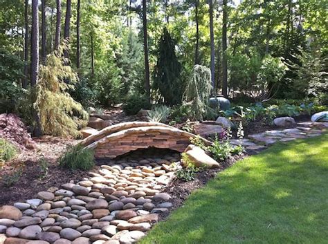 A Dry Creek Bed And Stone Bridge Were Installed To Solve Drainage