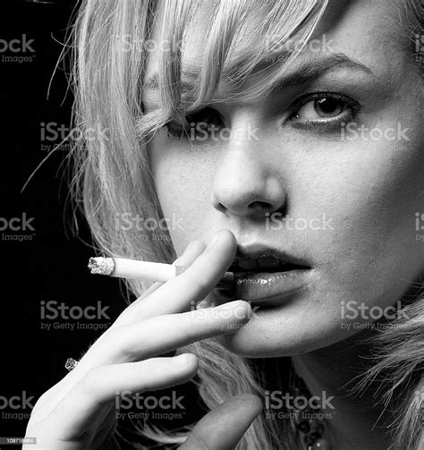 Portrait Of Young Woman Smoking Cigarette Black And White Stock Photo