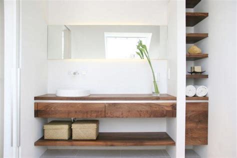 Depending on the color scheme of your bathroom, purchase or find some colored bottles. Wooden bathroom shelves