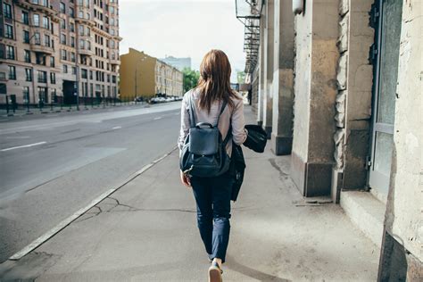 Back View Of A Hipster Girl Walking On City Street Edgewood Center