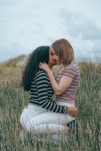 Two Lesbian Women Kissing On Top Of Each Other One Girl Is Latino And One Is Caucasian Image