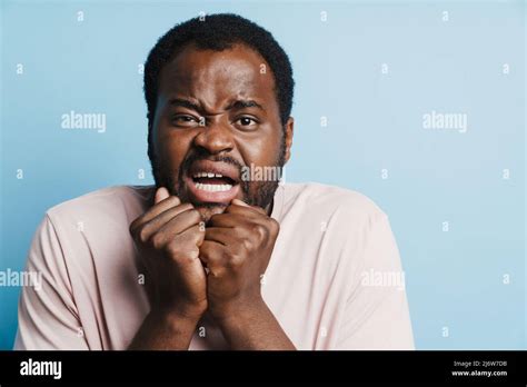 Black Scared Man Grimacing While Posing With Clenched Fists Isolated