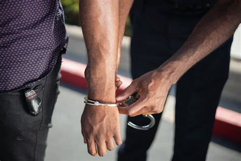 Police Officer Putting Handcuffs On Another Person · Free Stock Photo