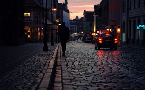 Silhouette Photo Of A Person Walking On Street Near Building During