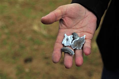 A Man Holds Shrapnel From A Missile Photograph By Ari Jalal Fine Art