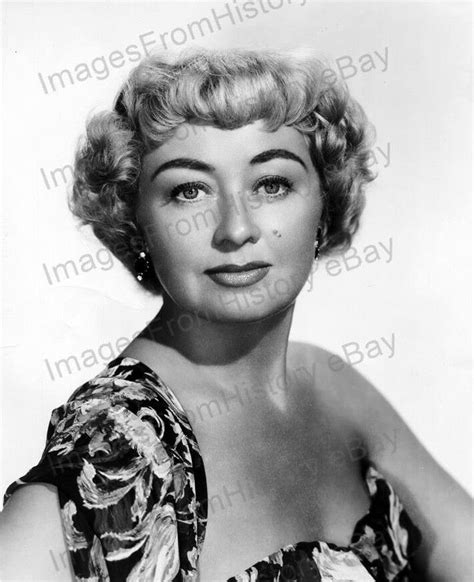 An Old Black And White Photo Of A Woman With Short Hair Wearing A Floral Dress