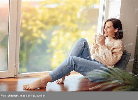 Beautiful Young Woman Drinking Coffee Near Window In Morning Stock