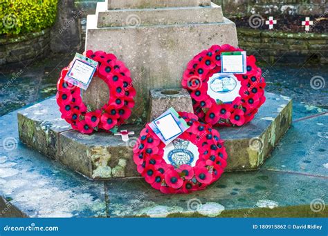 Poppy Wreaths Laid At The Foot Of The War Memorial In Remembrance Of