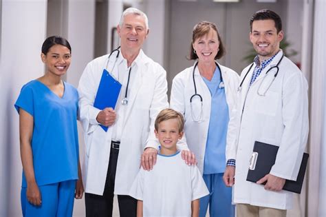 Premium Photo Doctors And Nurse Standing With Boy Patient In Hospital