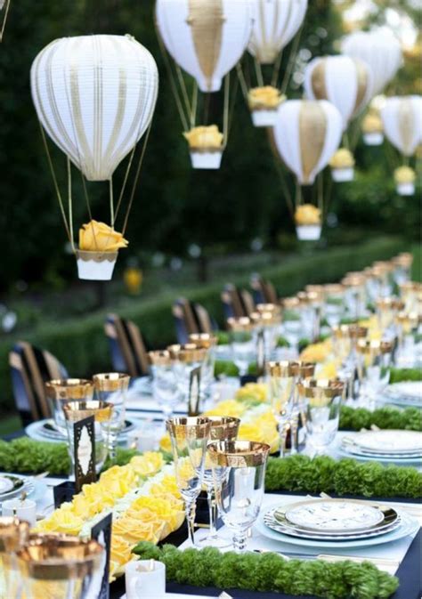 A Long Table Is Set With Plates And Hot Air Balloons In The Shape Of