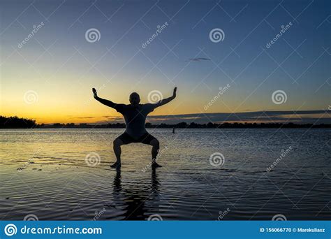 Sunrise Silhouette Of A Man On A Lake Stock Photo - Image of dawn ...