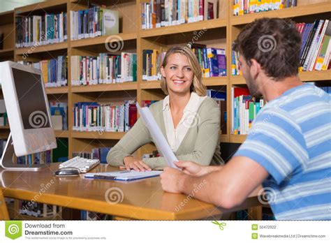 Student Getting Help From Tutor In Library Stock Photo Image Of Happy