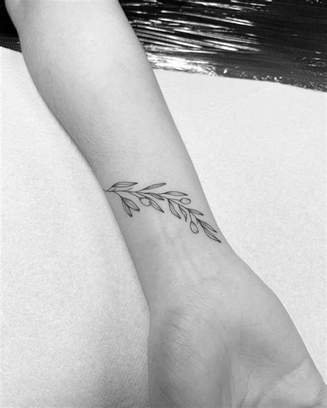 Fine Line Olive Branch Tattoo On The Wrist