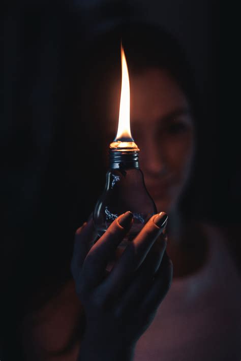 Woman Holding Lighted Oil Lamp · Free Stock Photo