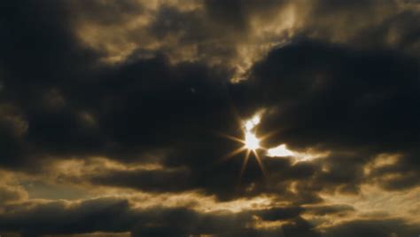 Time Lapse Of Beautiful Sun Rays Through Dark Storm Clouds In The Sky