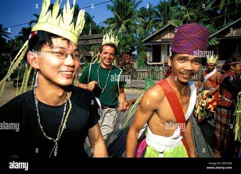 Kalimantan Tourists Dancing With Dayak Tribal People In Traditional