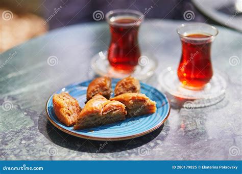 Turkish Tea Served In Tulip Shaped Glasses With Baklava Sweets In Cafe