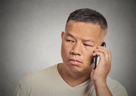 headshot upset sad depressed man worker talking on mobile phone stock image everypixel